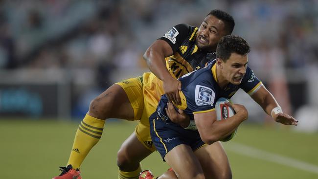 Matt Toomua of the Brumbies is tackled by Ngani Laumape of the Hurricanes.