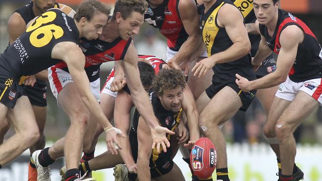 Glenelg’s Matthew Snook fights hard under pressure against West. Picture: Dean Martin/AAP