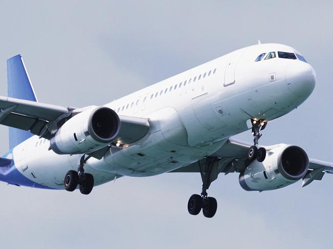 Passenger airliner flies above the clouds