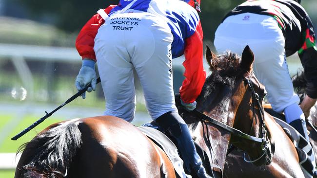 A jockey holding the whip during Melbourne Racing at Flemington Racecourse. (Photo by Vince Caligiuri/Getty Images)