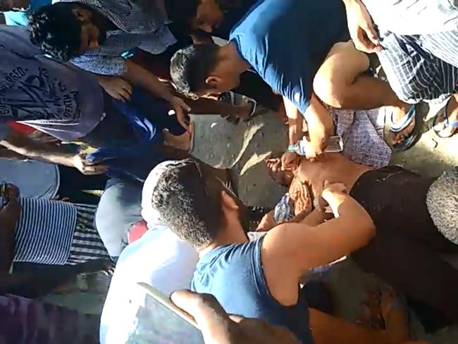 An asylum seeker collapses after police enter the Manus Island detention centre on Manus Island. Picture: GetUp
