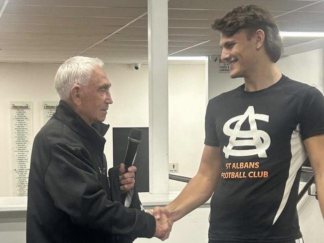 Joe Osborne receives his jumper from his grandfather, Ron. Picture: Supplied