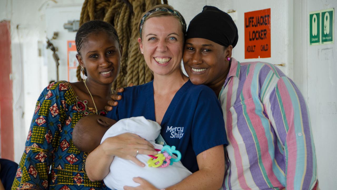 Deb Louden - Ward charge nurse (Australia) with patients and their baby