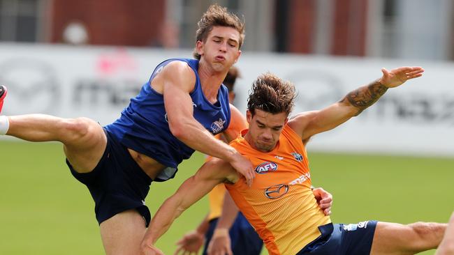 Will Phillips and Jy Simpkin collide at North Melbourne training.