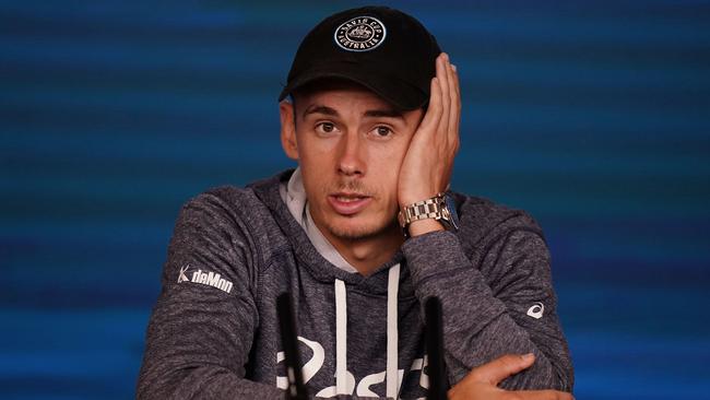 Alex de Minaur’s expression says it all after Australia’s No 1 in the men’s singles was forced to withdraw from the Australian Open with a stomach injury. Picture: AAP