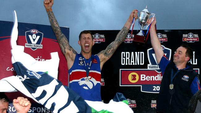 Wandin captain Robert Ross and coach Nick Rutley show off the silverware. Picture: Mark Dadswell