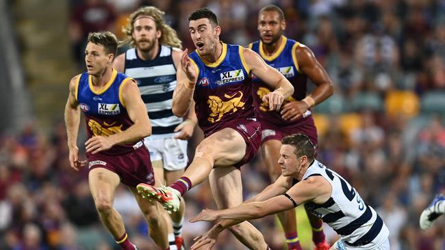 Daniel McStay of the Lions has his kick smothered by the Cats’ Mitch Duncan. Picture: Getty Images