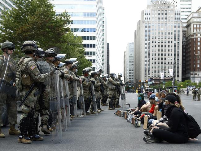 Protesters rally in front of Pennsylvania National Guard soldiers in Philadelphia. Picture: AP