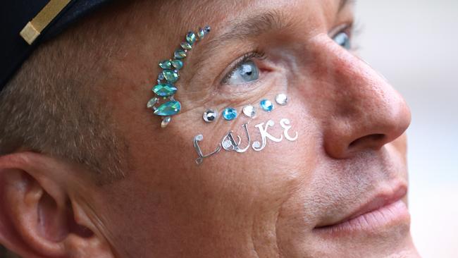 Luke Davies’ colleague and friend has his name adorned on his face at Sydney’s Mardi Gras. Picture: Chris Pavlich