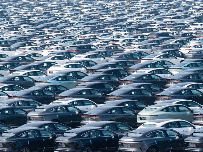 This aerial photo taken on October 15, 2023 shows newly-produced new energy electric vehicles parked at a distribution center of Changan Automobile in China's southwestern Chongqing. (Photo by AFP) / China OUT