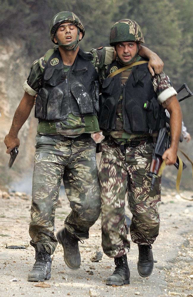 Region torn apart ... a Lebanese soldier helps a wounded comrade following an Israeli air raid on Beirut in July 2006. Israeli attacks began after three of its soldiers were killed and two abducted in a crossborder raid by Hezbollah. The conflict lasted 34 days.