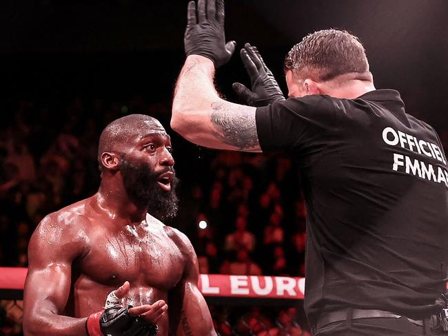 TOPSHOT - French-Cameroonian Cedric Doumbe (L) reacts as the referee stops the game during his welterweight bout against French Baysungur Baki Chamsoudinov as part of the Professional Fighters League Europe (PFL) event at the Accor Arena in Paris, on March 7, 2024. (Photo by FRANCK FIFE / AFP)