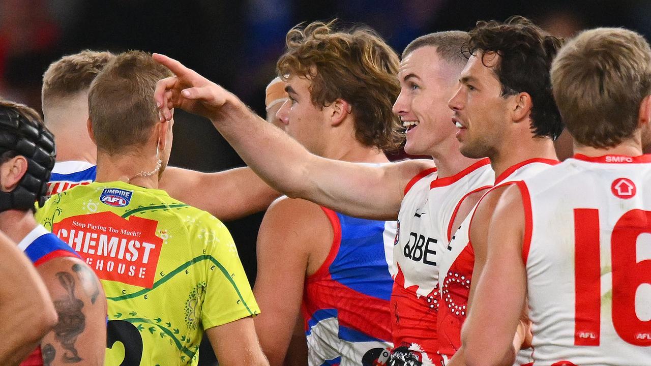 Warner points to the screen as replays rolled. (Photo by Morgan Hancock/Getty Images)