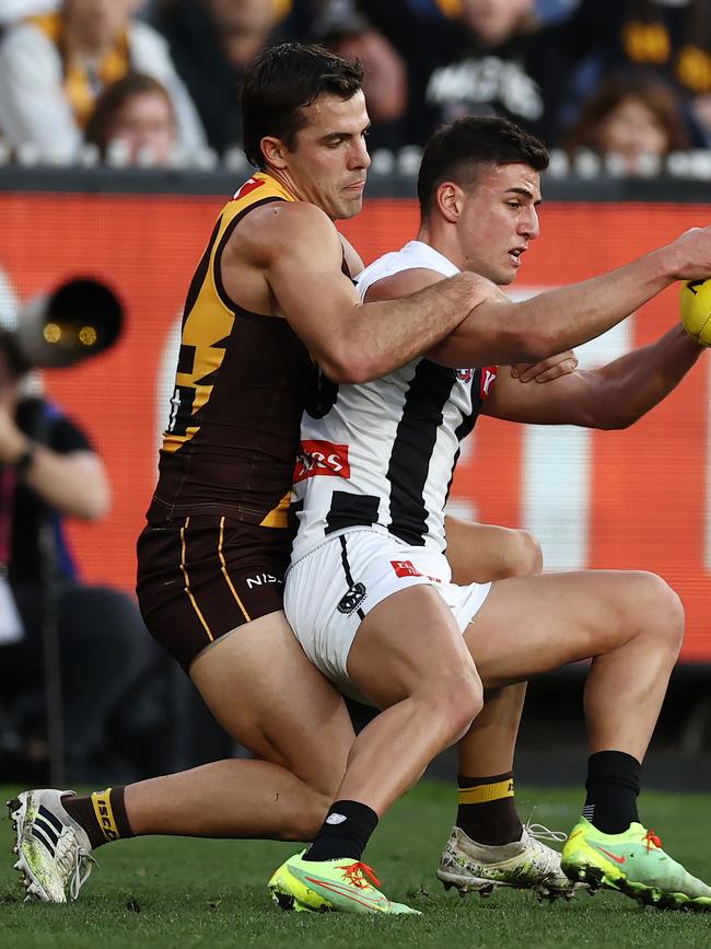 Nick Daicos of the Magpies tackled by Finn Maginness of the Hawks in round 21, where the Pie young gun nearly missed the rest of the season with a knee injury. Photo by Michael Klein.