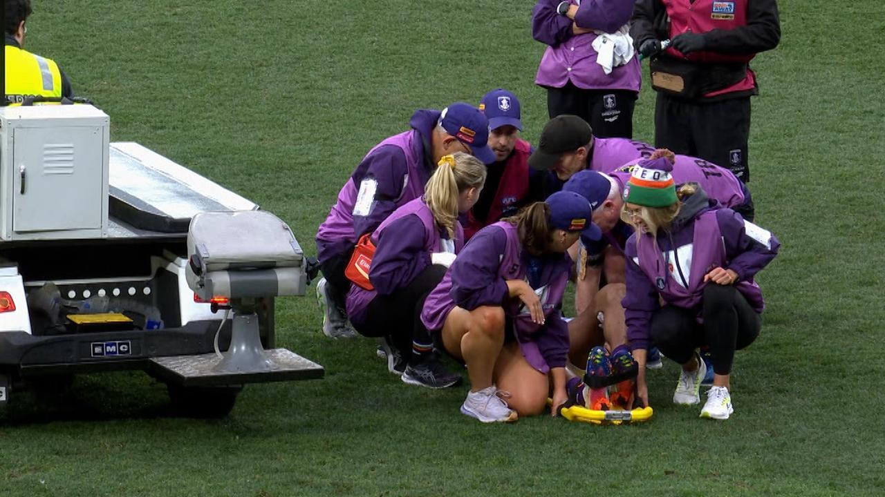 Medical staff quickly get to Brandon Walker's aid at the MCG.