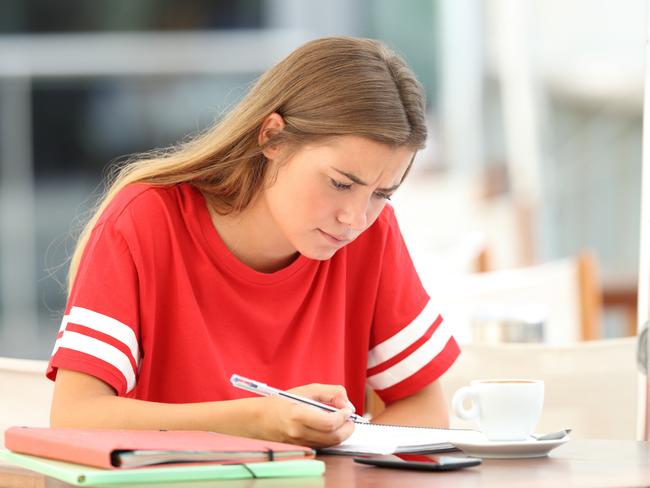 Single confused student studying reading notes sitting in a bar stressed high school kids . Picture: istock