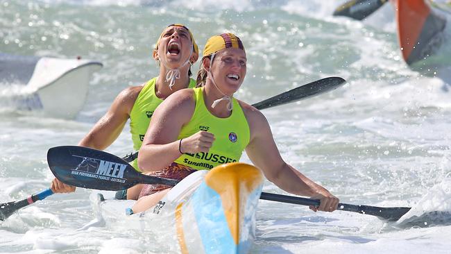 Jaime Roberts and Hannah Minogue in the surf.