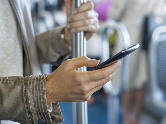 Female with smartphone in public transport. Close up on hands.Escape 7 June 2024101Photo - iStock