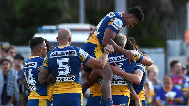 ROCKHAMPTON, AUSTRALIA – SEPTEMBER 12: Waqa Blake of the Eels jumps in his teammates as Mitchell Moses of the Eels celebrates with his teammates after scoring a try during the NRL Elimination Final match between Parramatta Eels and Newcastle Knights at Browne Park, on September 12, 2021, in Rockhampton, Australia. (Photo by Albert Perez/Getty Images)