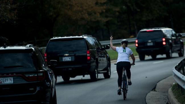 Juli Briskman won the internet when she gave Donald Trump the finger as his motorcade passed her in Virginia. Picture: AFP / Brendan Smialowski