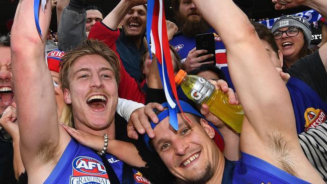 Smith (right) celebrates the Bulldogs’ 2016 premiership defeat of the Swans.