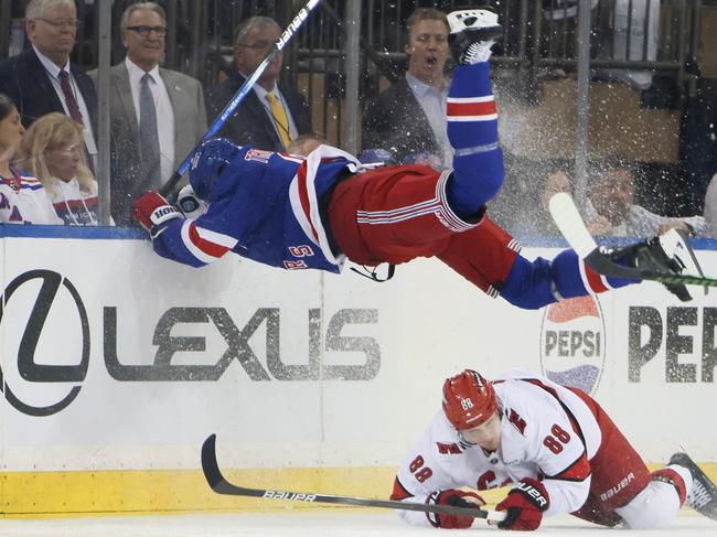 NEW YORK, NEW YORK - MAY 07: Jacob Trouba #8 of the New York Rangers jumps over Martin Necas #88 of the Carolina Hurricanes during the third period in Game Two of the Second Round of the 2024 Stanley Cup Playoffs at Madison Square Garden on May 07, 2024 in New York City.   Bruce Bennett/Getty Images/AFP (Photo by BRUCE BENNETT / GETTY IMAGES NORTH AMERICA / Getty Images via AFP)