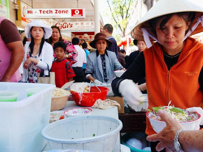 A volunteer from the Phoc Hau Budhist Temple in Cabramatta prepares a dish of Bun Rieu at the moon festival in 2004. Picture: Mat Sullivan