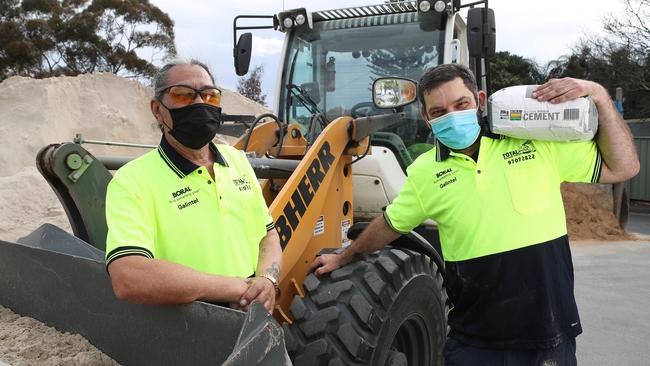 Workers at Total Building Supplies in Punchbowl, including manager “TK” and Mark Ayoub, are adapting to new Covid rules to make sure they can keep supplying tradies across Sydney. Picture: David Swift