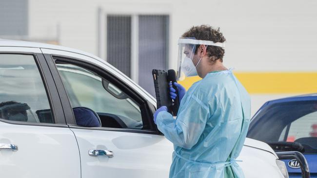 Lines of cars and health workers at the Victoria Park Covid testing clinic in Adelaide. Picture: NCA NewsWire / Brenton Edwards