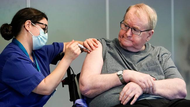 Svein Andersen, 67, becomes the first person in Norway to receive the Pfizer-Biontech COVID-19 vaccine on December 27. Picture: AFP