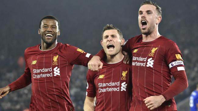 Liverpool's James Milner, centre, celebrates with teammate Georginio Wijnaldum, left, and Jordan Henderson after scoring his side's second goal. Picture: AP