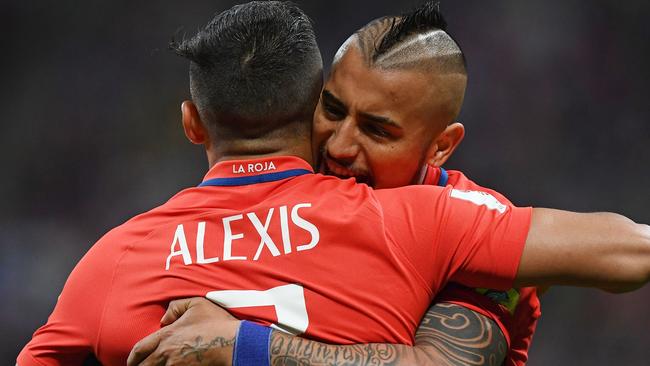 Chile's forward Alexis Sanchez (R) is congratulated by Chile's midfielder Arturo Vidal