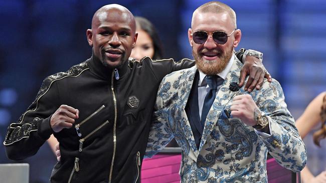 LAS VEGAS, NV — AUGUST 26: Floyd Mayweather Jr. (L) and Conor McGregor pose for pictures during a news conference after Mayweather's 10th-round TKO victory in their super welterweight boxing match on August 26, 2017 at T-Mobile Arena in Las Vegas, Nevada. Ethan Miller/Getty Images/AFP == FOR NEWSPAPERS, INTERNET, TELCOS &amp; TELEVISION USE ONLY ==