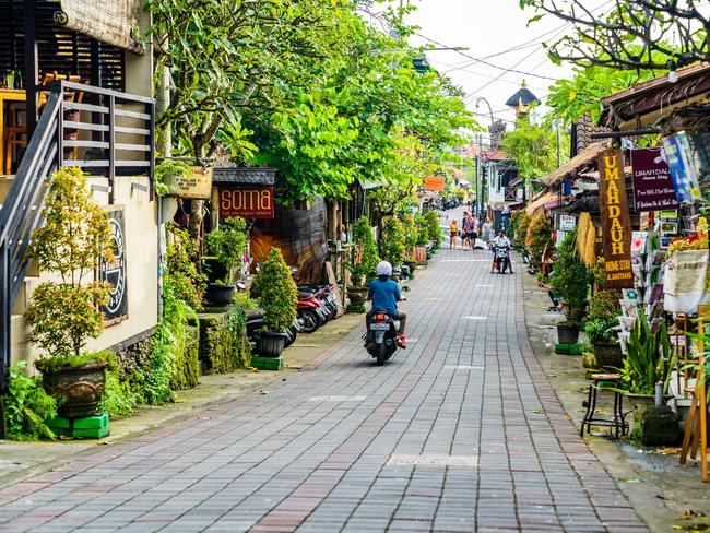 Tourists strolling along the central street of Ubud. Ubud is the cultural heart of Bali. It's full of restaurants, yoga studios, spaÃ¢â‚¬â„¢s and shops. This traditional country town is home to one of Bali's royal families.Escape 7 January 2024Eds LetterPhoto - iStock