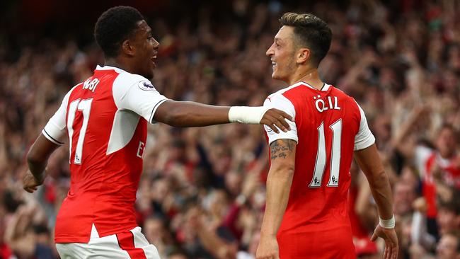 Mesut Ozil of Arsenal (R) celebrates scoring his side’s third goal.