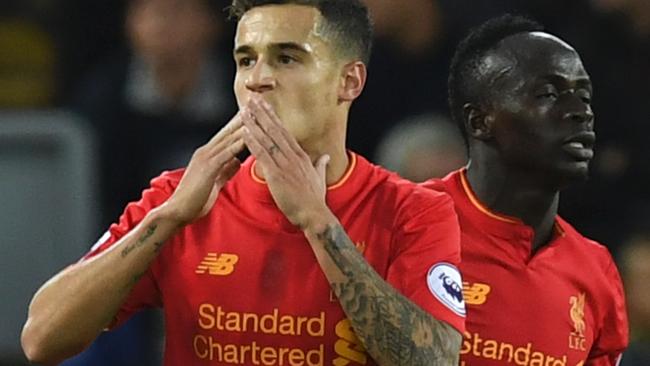 Liverpool's Brazilian midfielder Philippe Coutinho (L) celebrates scoring their second goal with Liverpool's Senegalese midfielder Sadio Mane (R) during the English Premier League football match between Liverpool and West Bromwich Albion at Anfield in Liverpool, north west England on September 10, 2016. / AFP PHOTO / PAUL ELLIS / RESTRICTED TO EDITORIAL USE. No use with unauthorized audio, video, data, fixture lists, club/league logos or 'live' services. Online in-match use limited to 75 images, no video emulation. No use in betting, games or single club/league/player publications. /