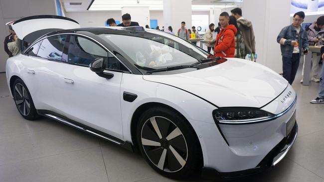 Visitors look at Luxeed S7, the first sedan produced by Chinese tech giant Huawei, at a Huawei showroom in Hangzhou, in China’s eastern Zhejiang province. Picture: AFP / China OUT