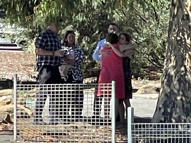 Staff at Bendigo South East Secondary College comforting each other after a child was struck by a car on the corner of Curtin and Burrell Streets on Thursday.