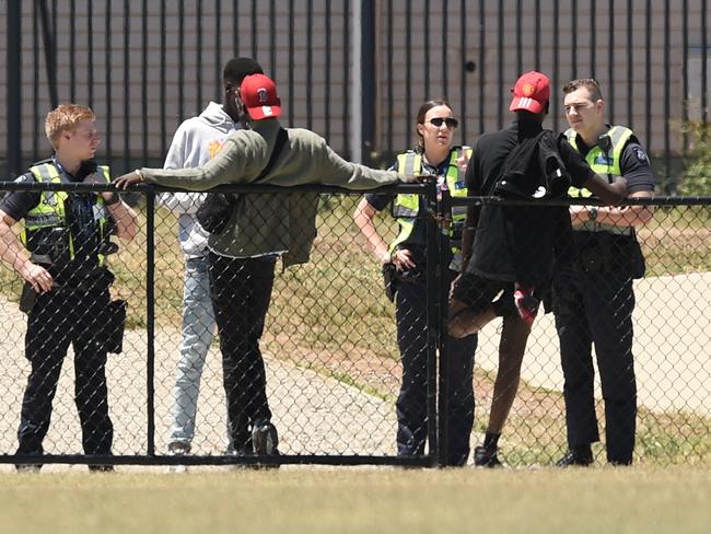 Police talk to youths at the trashed Ecoville Community Park in Tarneit. Picture: Nicole Garmston