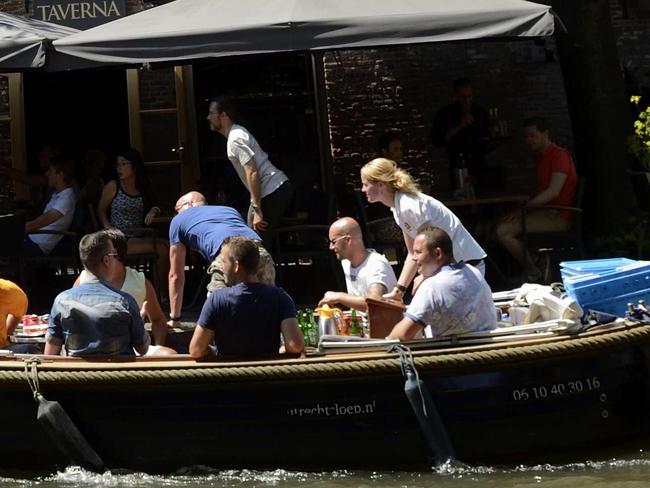 A flag bearing the Tour de France logo is seen on a building along a canal on July 1, 2015 in Utrecht, The Netherlands, three days before the start of the 102th edition of the Tour de France cycling race. The 2015 Tour de France gets underway on July 4 in the streets of Utrecht and ends on July 26, 2015 down the Champs-Elysees in Paris. AFP PHOTO / ERIC FEFERBERG