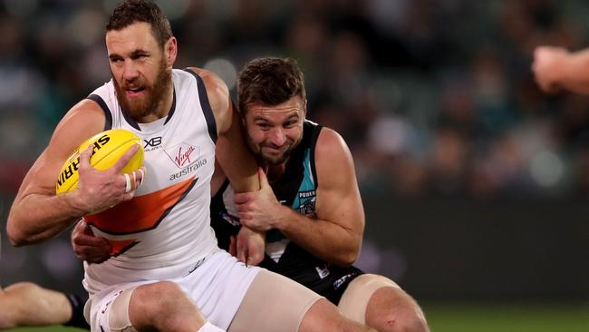 Sam Gray takes down Shane Mumford on Saturday night. Picture: James Elsby (Getty).