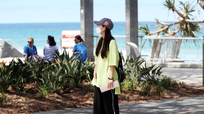 A woman wears a mask in Surfers Paradise. Picture: Nigel Hallett