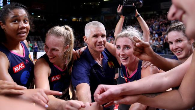 Lightning coach Chris Lucas celebrates with his players after winning game two of the grand final series against UC Capitals at Titanium Security Arena. Picture: AAP Image/Kelly Barnes