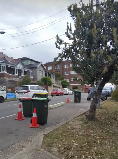 Parts of this street have been blocked off by bins and cones without any prior notice to local residents.