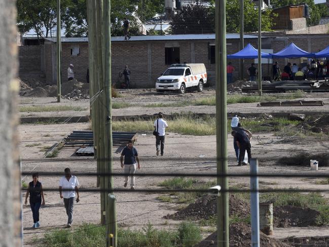 Police work in the  block of land  next to the home of Gilad Pereg where the bodies of his mother and aunt were found in Mendoza, Argentina. Picture: AP 