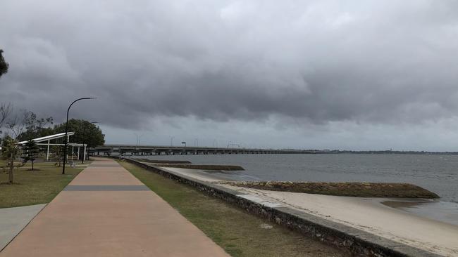 Storm clouds gather over Sandgate on Tuesday afternoon. Picture: Mark Cranitch.