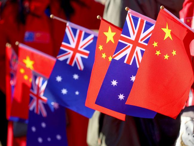 ADELAIDE, AUSTRALIA - NewsWire Photos - 16 JUNE, 2024:  Supporters of Chinese Premier Li Qiang hold Australian and Chinese flags as they wait for his arrival at Magill Estate winery in Adelaide on June 16, 2024. Picture: NewsWire / Kelly Barnes / POOL