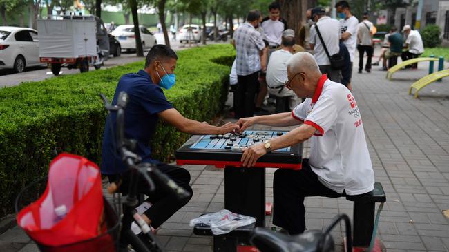 Men play chess at a park in Beijing on Friday. Picture: AFP