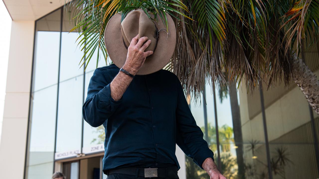 Peter Scammell hides his face from waiting media outside court on Friday. Picture: Pema Tamang Pakhrin