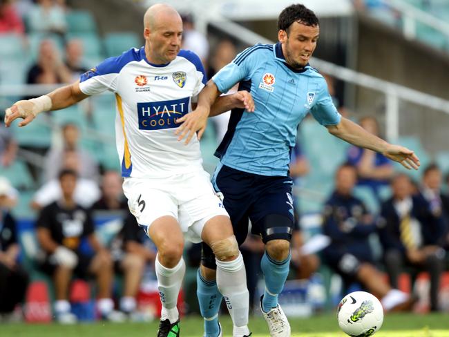 Gold Coast United’s Kristian Rees battles Sydney’s Mark Bridge in 2012. Picture: Gregg Porteous